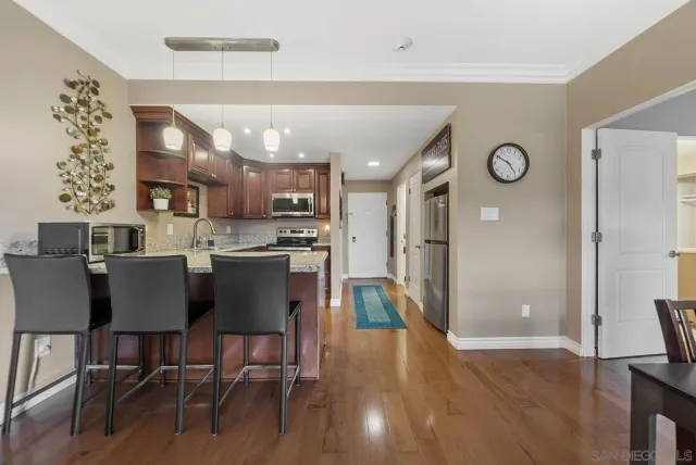 a kitchen with stainless steel appliances granite countertop a refrigerator a stove top oven a sink and dishwasher