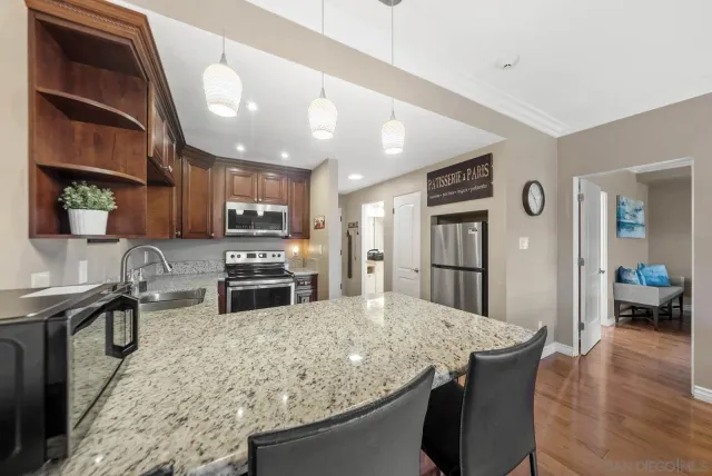 a living room with furniture a fireplace and a large window