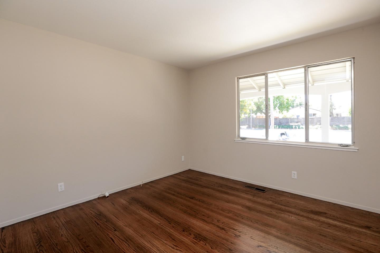 979 West Homestead Road Sunnyvale, CA 94087 - Photo 12 of 16 a view of an empty room with wooden floor and a window