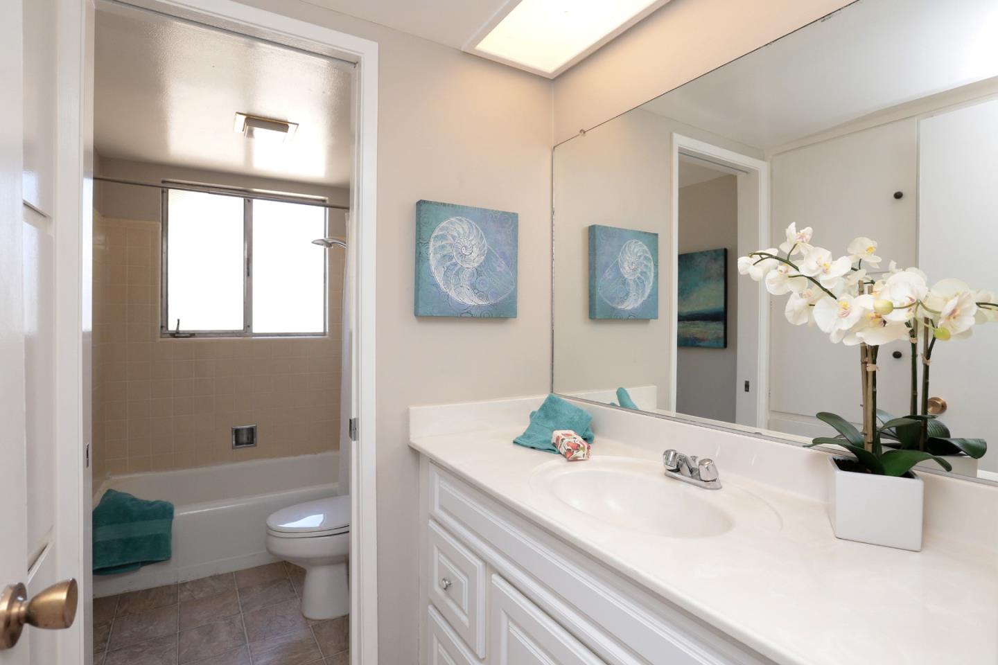 979 West Homestead Road Sunnyvale, CA 94087 - Photo 14 of 16 a bathroom with a granite countertop sink a toilet and a large mirror