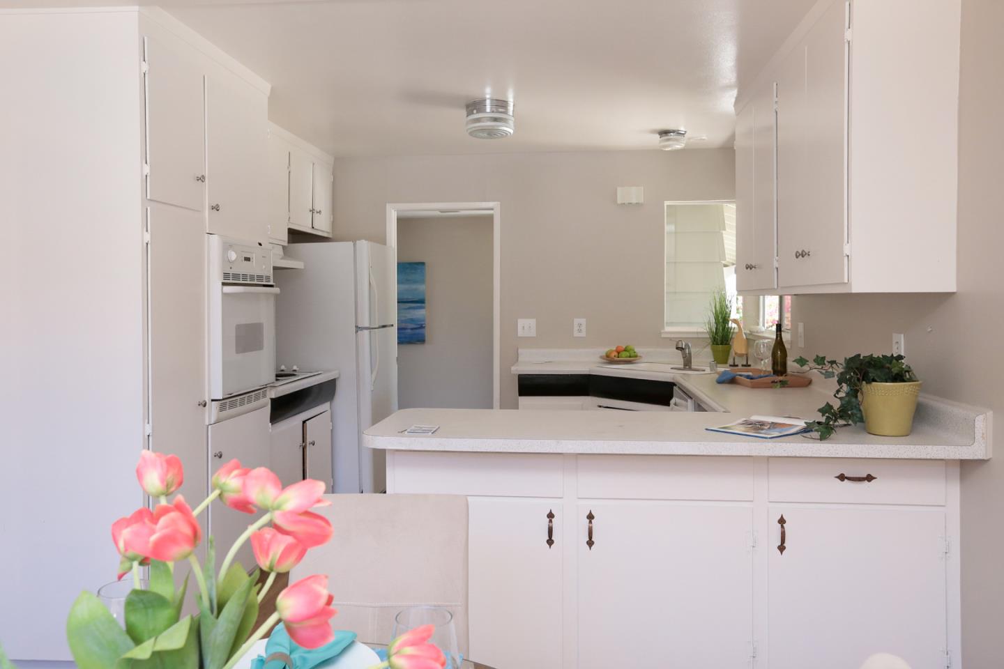 979 West Homestead Road Sunnyvale, CA 94087 - Photo 10 of 16 a kitchen with a sink refrigerator and cabinets