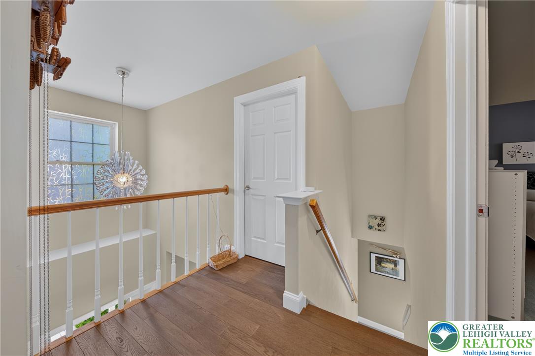 1702 Red Bud Road Quakertown, PA 18951 - Photo 27 of 68 Rich hardwood flooring guides you across this upper-level hallway with a decorative pendant light.