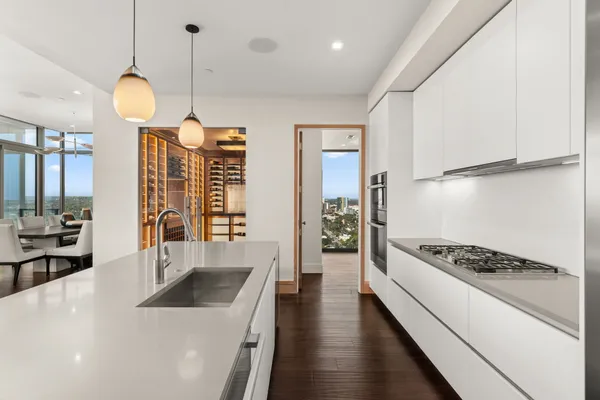 a kitchen with stove and white cabinets