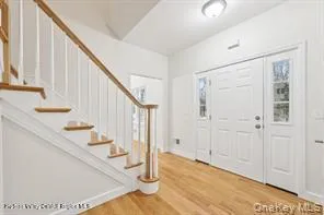 a view of an entryway with wooden floor
