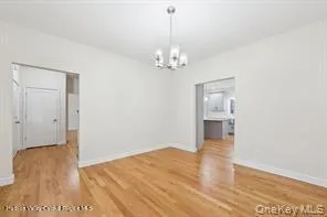 a view of livingroom with hardwood floor and kitchen view