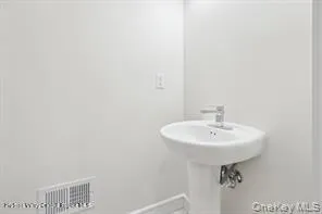 a bathroom with a sink a mirror and a toilet