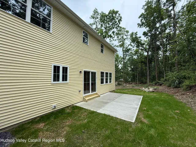 a view of backyard of house and garage
