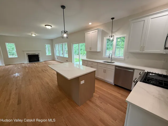 a large kitchen with kitchen island a sink stainless steel appliances and cabinets