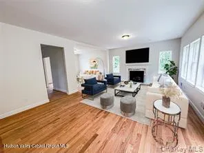 a living room with furniture a flat screen tv and a fireplace