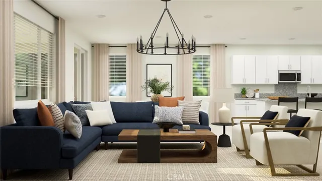 a living room with furniture ceiling fan and a window