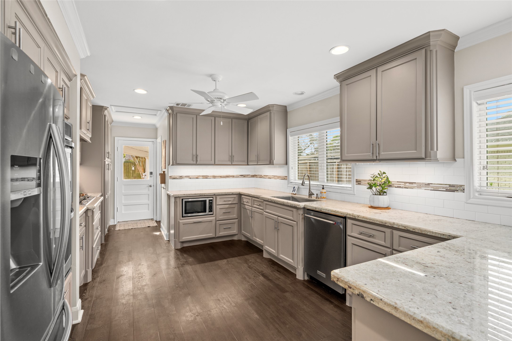 7805 Valley View Lane Houston, TX 77074 - Photo 12 of 29 a kitchen with granite countertop a sink stove and refrigerator