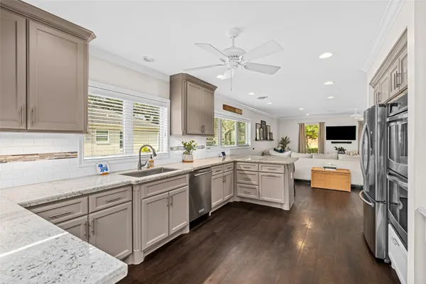 a kitchen with white cabinets and sink