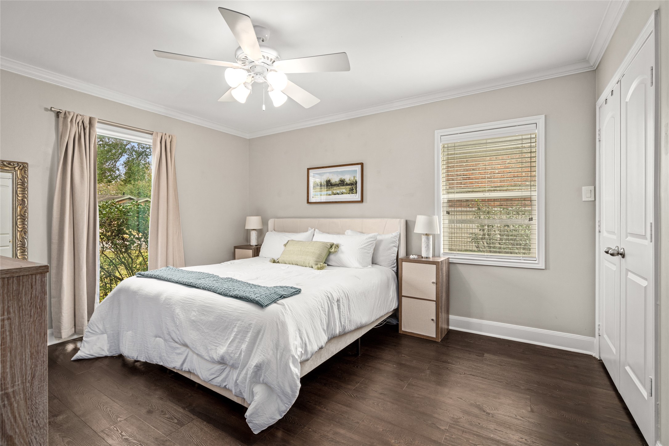 7805 Valley View Lane Houston, TX 77074 - Photo 15 of 29 a bedroom with a large bed chandelier and a window