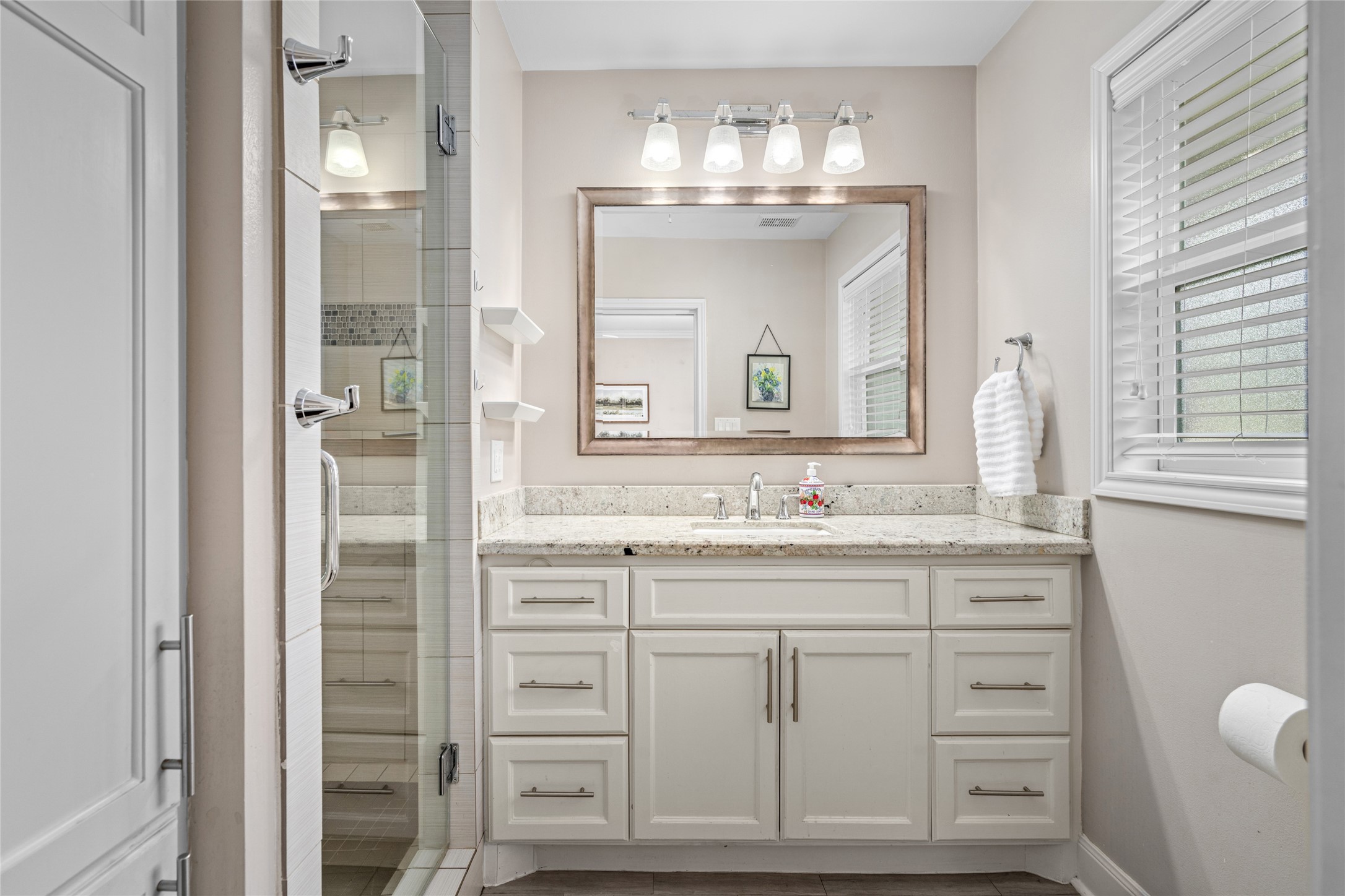 7805 Valley View Lane Houston, TX 77074 - Photo 16 of 29 a bathroom with a granite countertop sink a mirror and a vanity