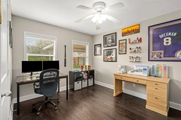 a view of a workspace with furniture and a window