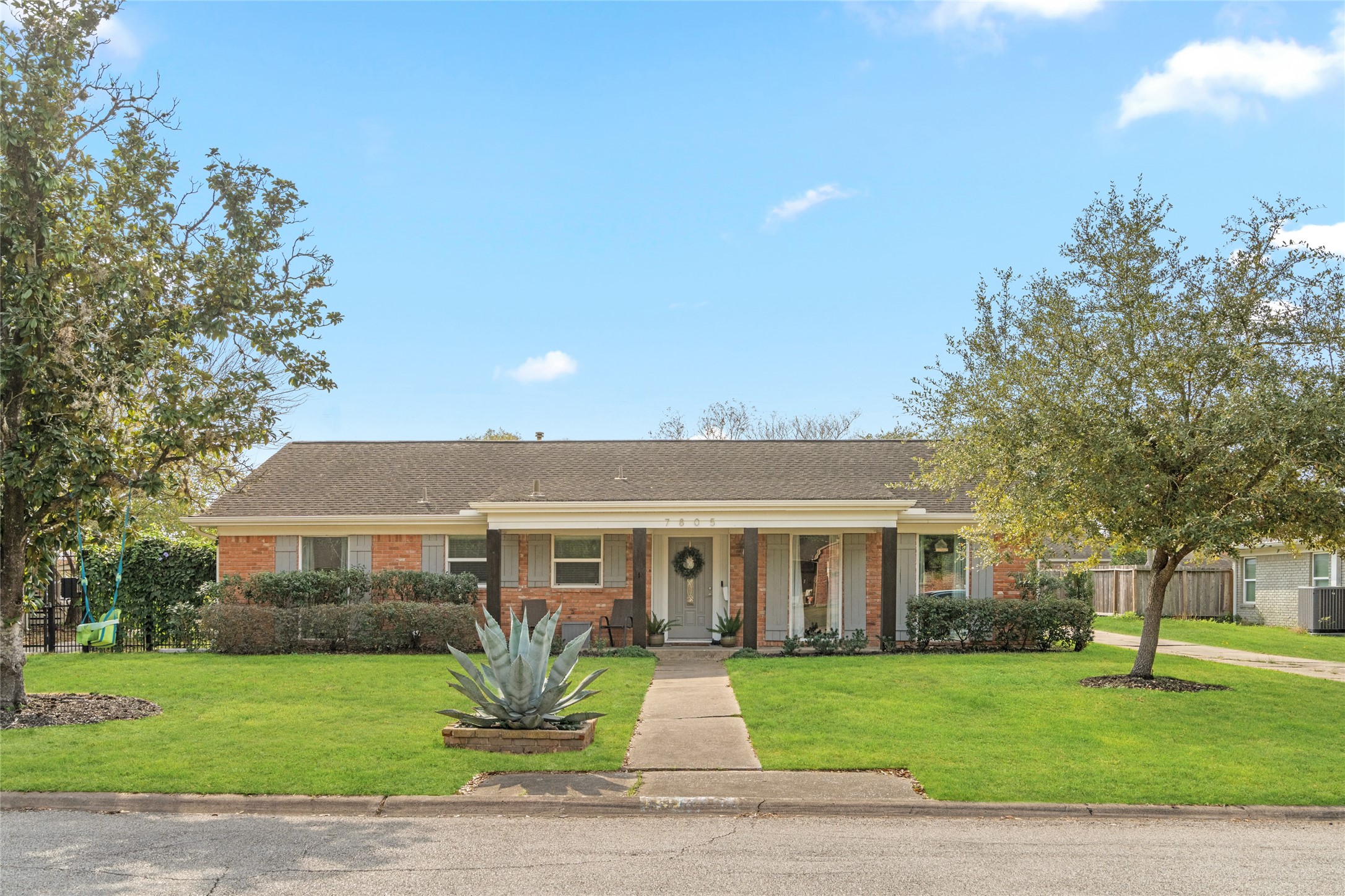 7805 Valley View Lane Houston, TX 77074 - Photo 2 of 29 a front view of a house with a garden