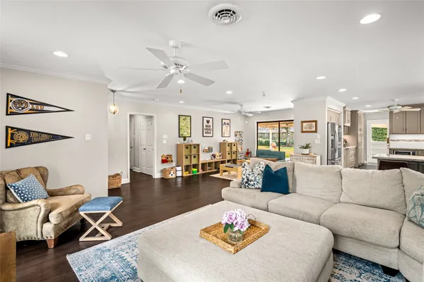 a living room with furniture kitchen view and a table