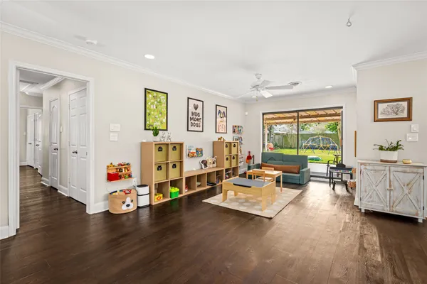 a living room with furniture and wooden floor