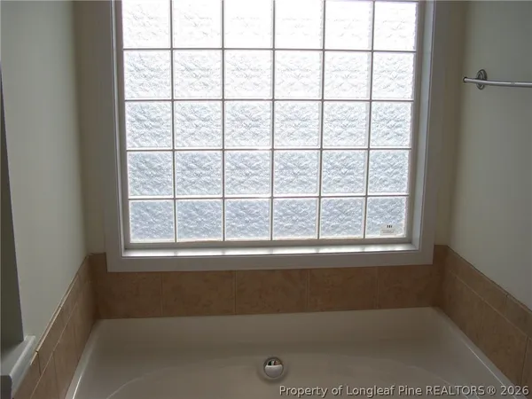 a view of a bath tub sitting in a bathroom next to a window