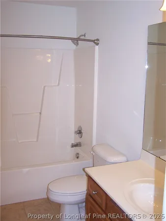 a white toilet sitting next to a bath tub