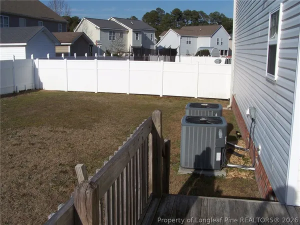 a view of a house with wooden fence