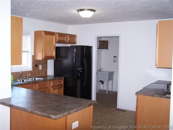 a kitchen with stainless steel appliances granite countertop a refrigerator and a stove