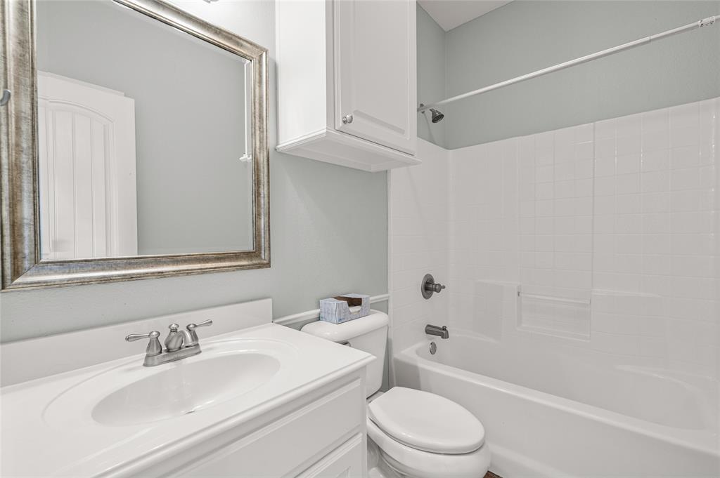 10264 Farmington Road Van Alstyne, TX 75495 - Photo 23 of 39 a bathroom with a sink a toilet and shower