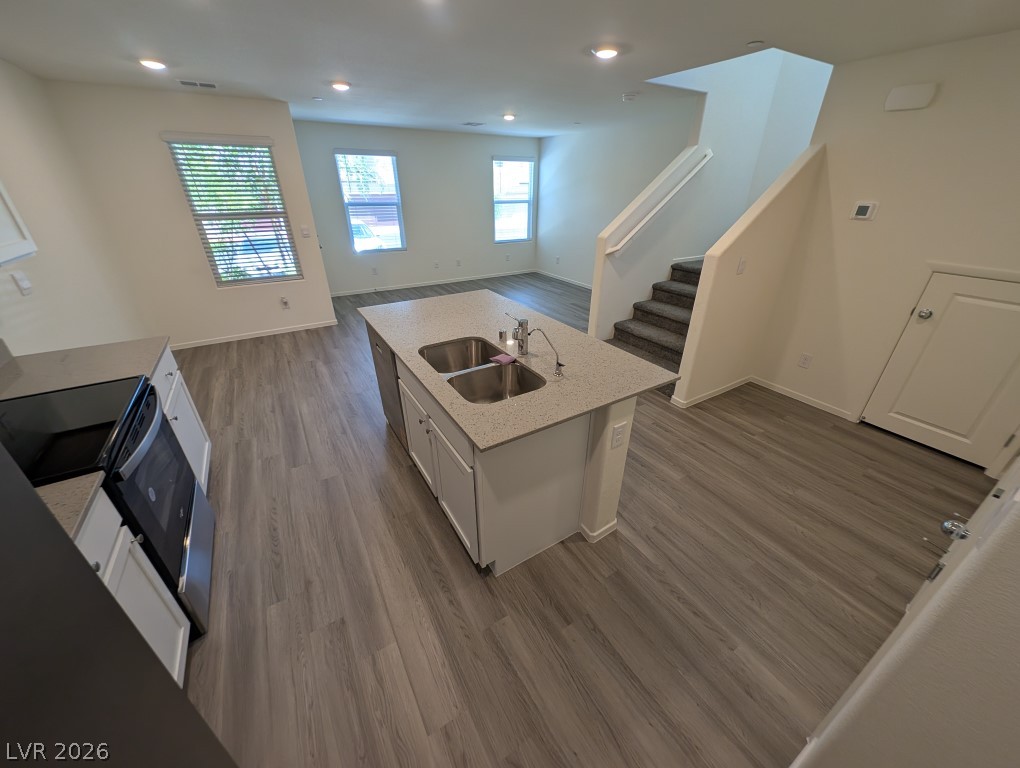4820 Orchid Rdg Avenue Las Vegas, NV 89141 - Photo 12 of 27 A well-appointed kitchen island anchors this open-concept living space, with modern appliances and durable flooring.