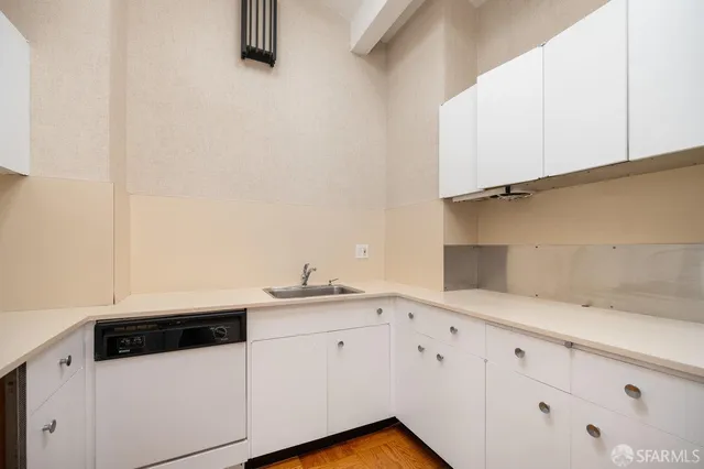 a view of kitchen and hall with wooden floor