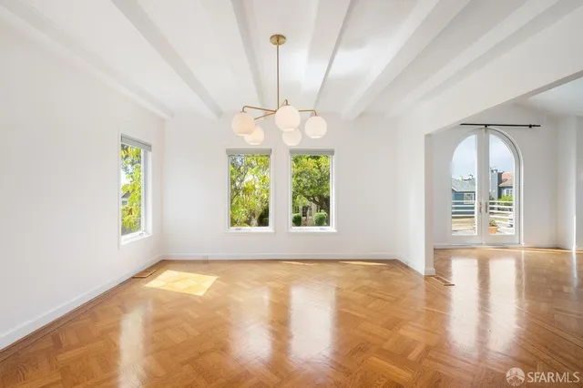 a view of a room with wooden floor and a fireplace