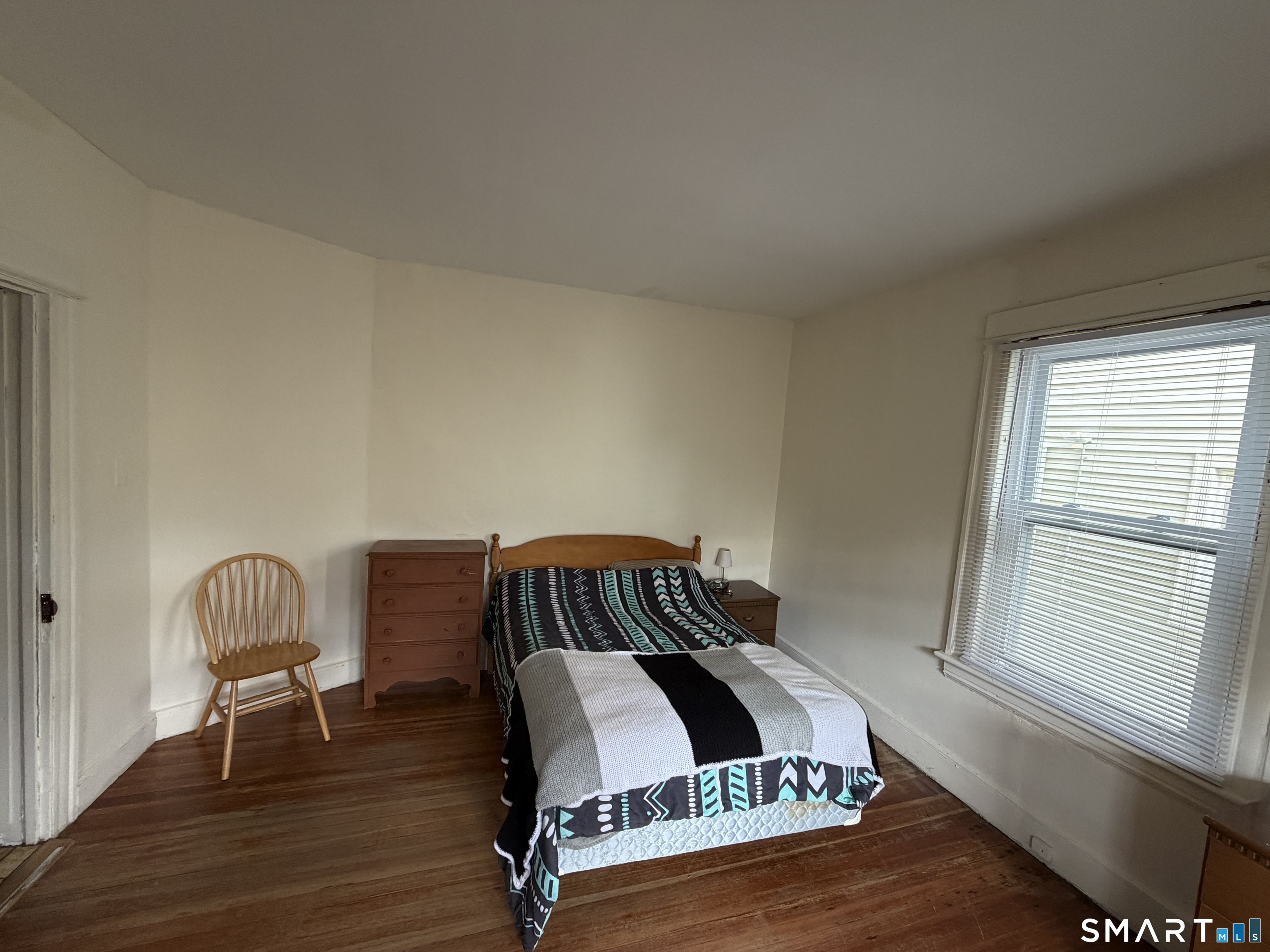 593 Wayne Street Bridgeport, CT 06606 - Photo 13 of 20 a view of a bedroom with furniture and wooden floor