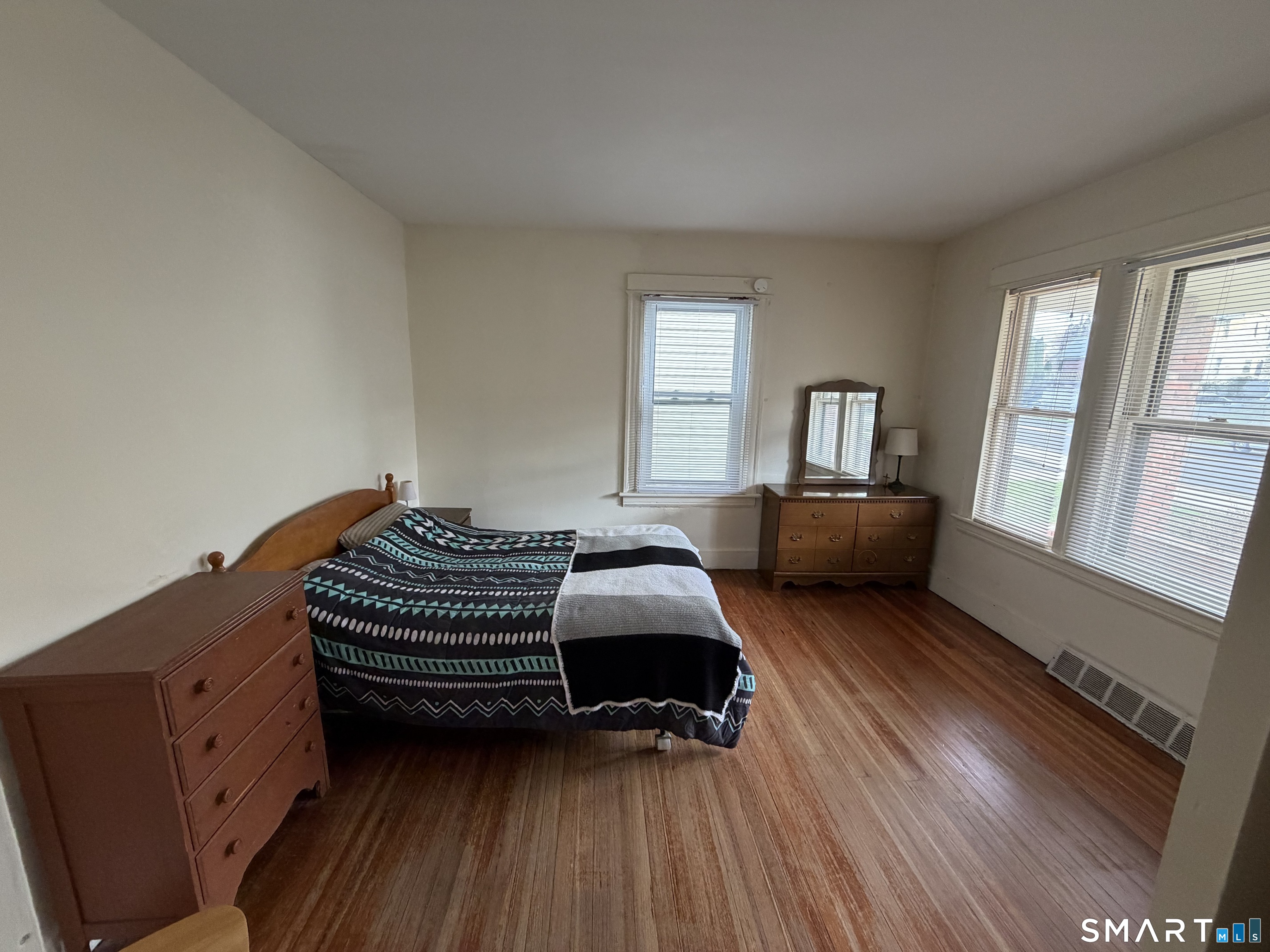 593 Wayne Street Bridgeport, CT 06606 - Photo 14 of 20 a bedroom with a bed and wooden floor