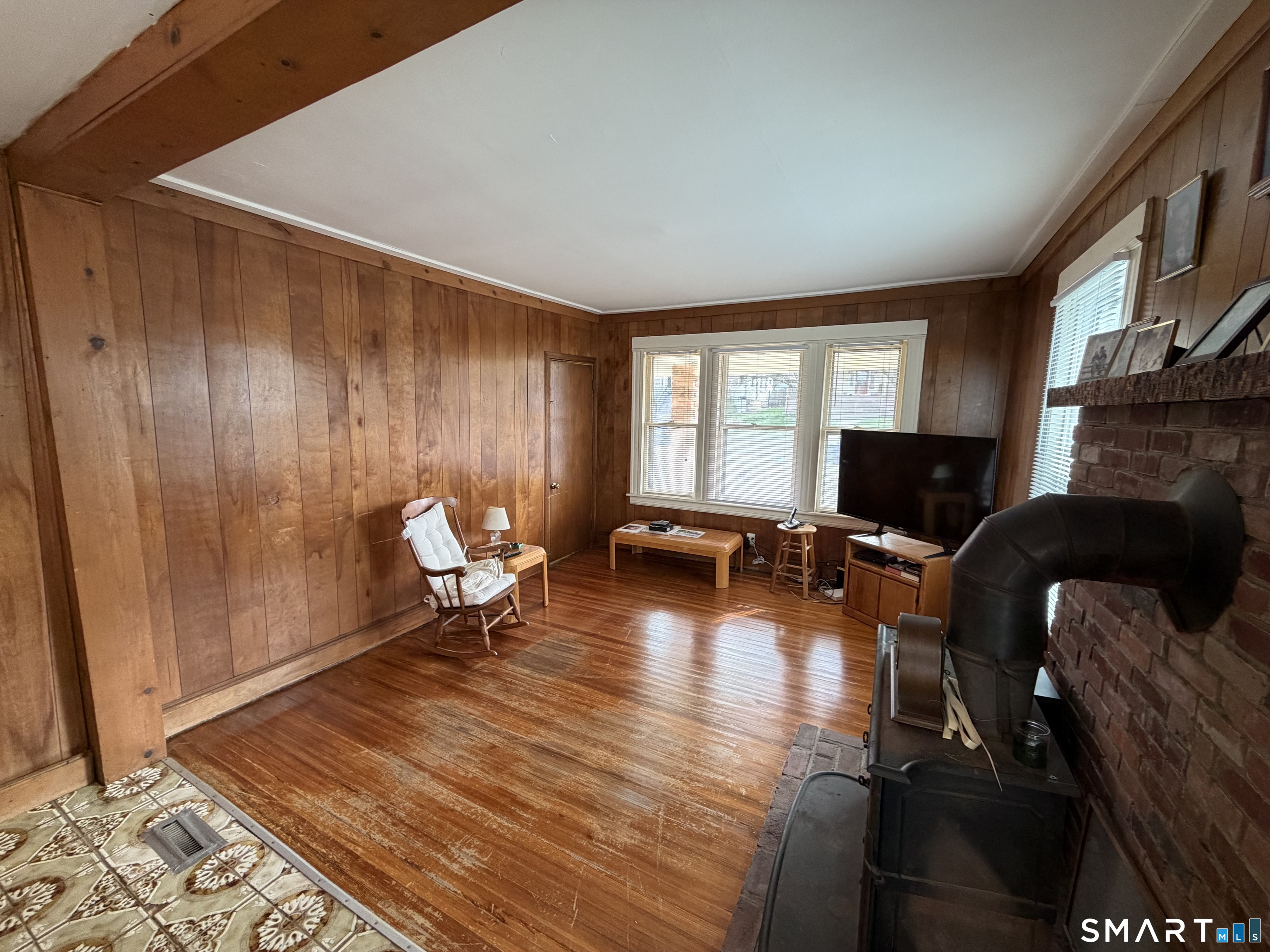 593 Wayne Street Bridgeport, CT 06606 - Photo 16 of 20 a living room with furniture a flat screen tv and a fireplace