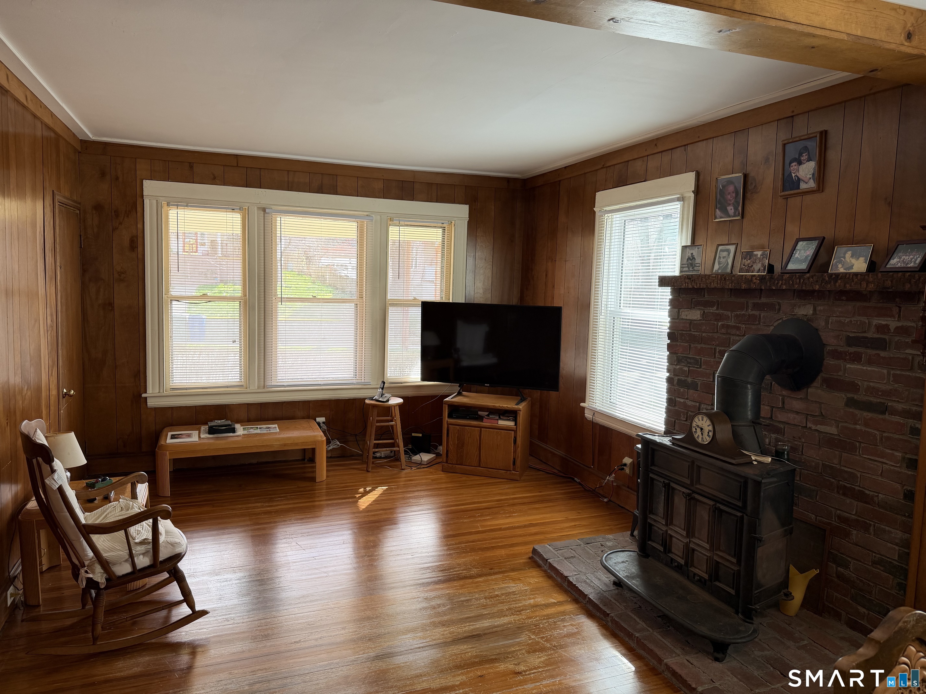 593 Wayne Street Bridgeport, CT 06606 - Photo 18 of 20 a living room with furniture flat screen tv and a fireplace
