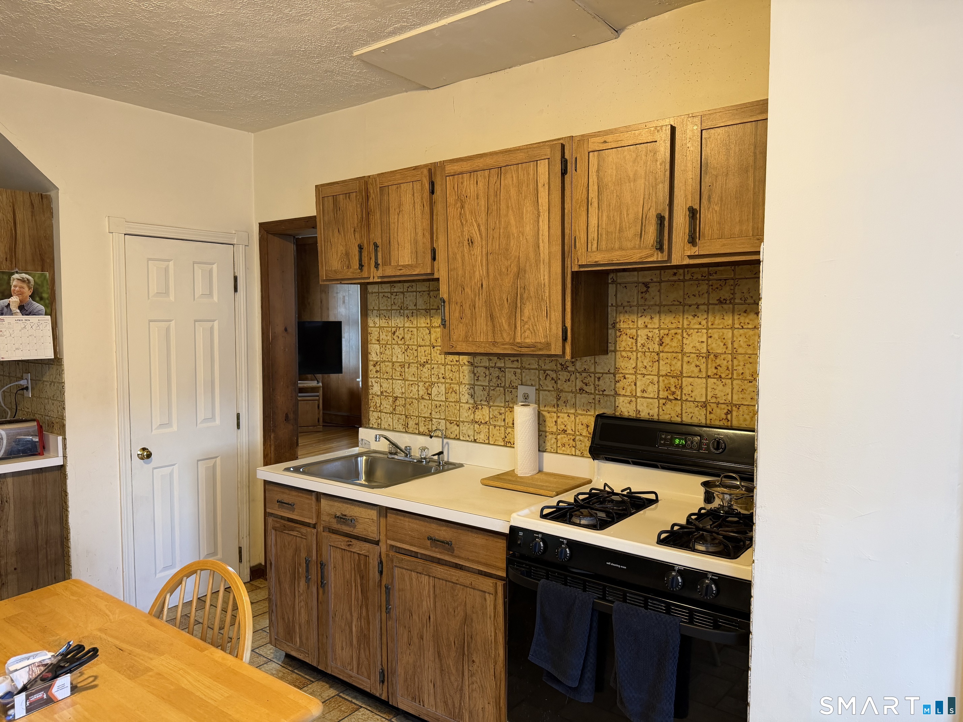 593 Wayne Street Bridgeport, CT 06606 - Photo 8 of 20 a kitchen with stainless steel appliances a stove a sink and a refrigerator
