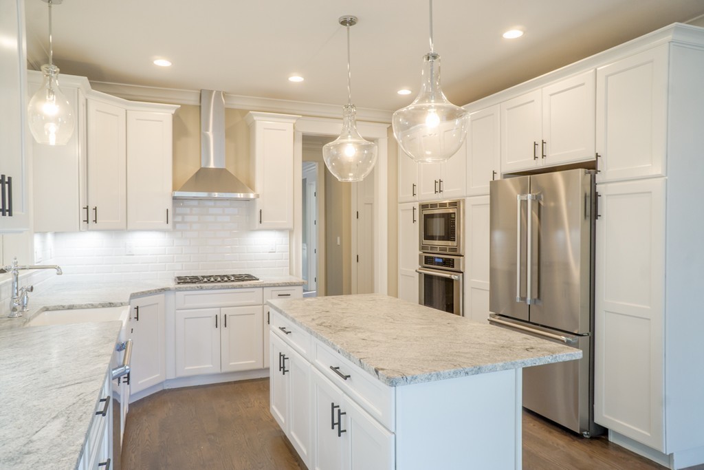 a kitchen with a sink stainless steel appliances and window