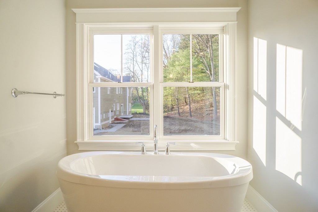 322 Maynard Road Sudbury, MA 01776 - Photo 12 of 24 a white bath tub sitting in a bathroom next to a window