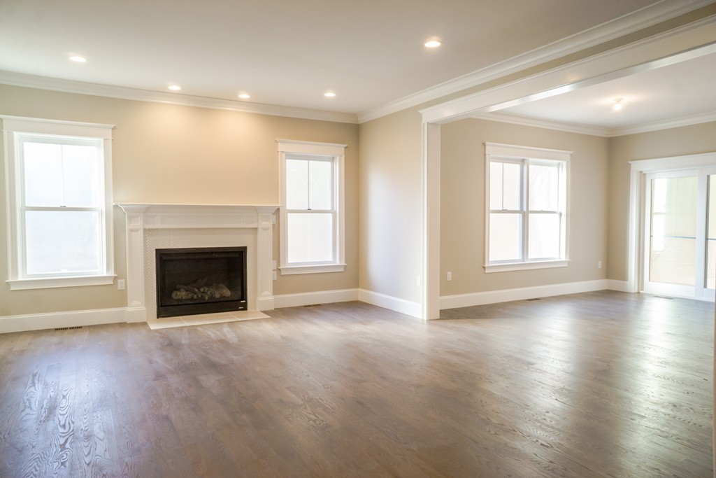 322 Maynard Road Sudbury, MA 01776 - Photo 3 of 24 an empty room with wooden floor fireplace and windows