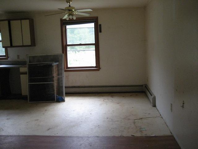 199 Polikoff Road Sheffield, MA 01222 - Photo 3 of 10 an empty room with a fireplace and window