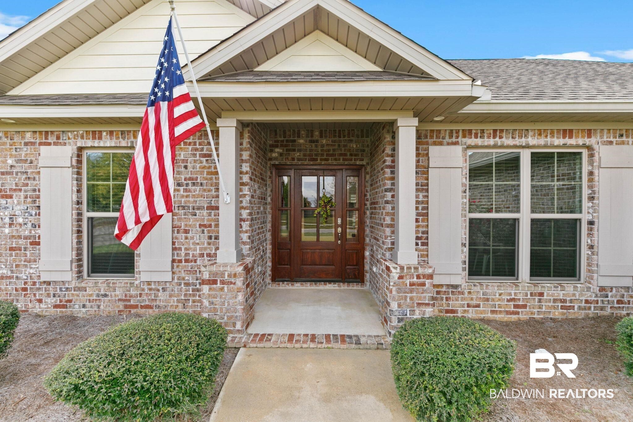 9388 Pembrook Loop Fairhope, AL 36532 - Photo 7 of 53 Property entrance featuring covered porch, brick siding, and a shingled roof