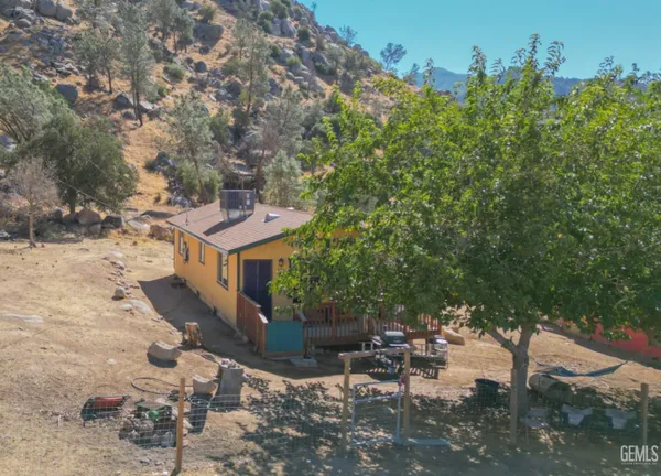 a view of a chairs and table in the patio