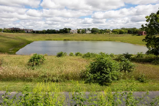 a view of a lake with houses in the back