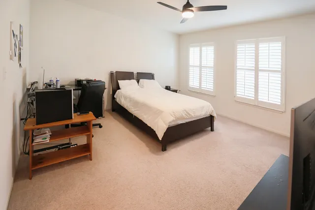 a bedroom with bed and window