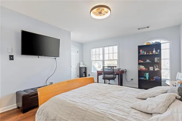 a bedroom with a bed and a flat screen tv