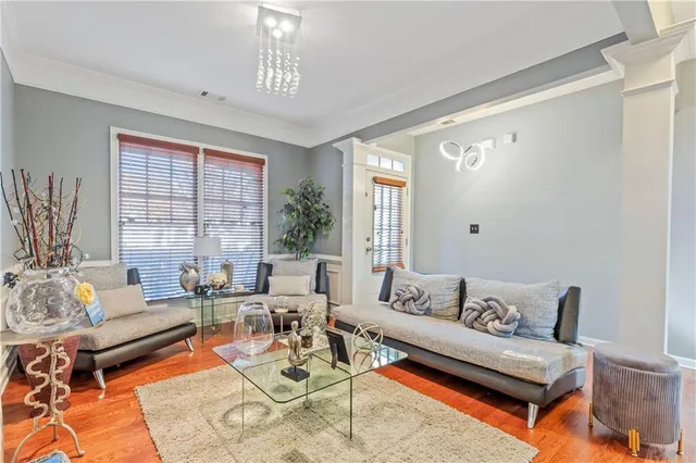 a living room with furniture and a chandelier