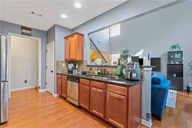 a kitchen with stainless steel appliances granite countertop a sink and cabinets