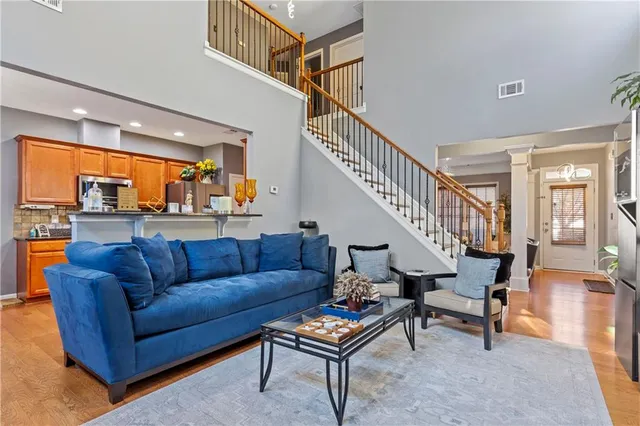 a living room with furniture a rug and a chandelier