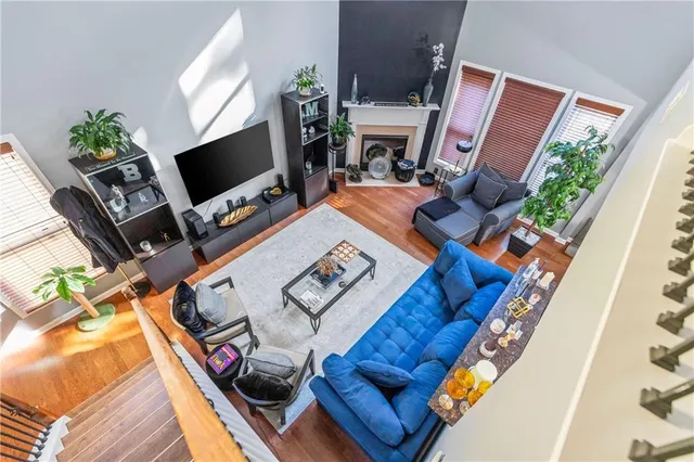 a living room with furniture a flat screen tv and a fireplace