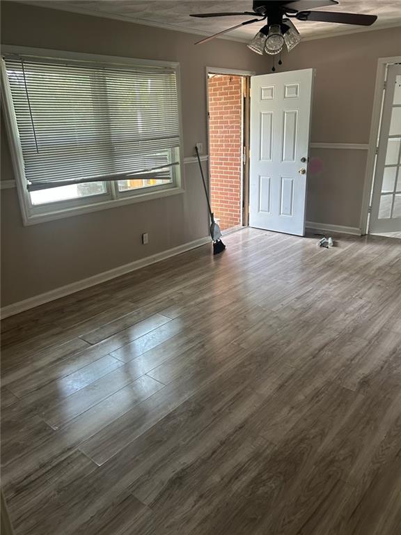 2418 Adger Road Macon, GA 31206 - Photo 2 of 5 an empty room with wooden floor and windows