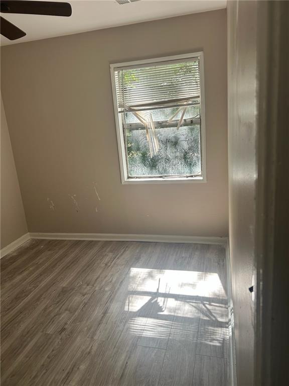 2418 Adger Road Macon, GA 31206 - Photo 3 of 5 a view of empty room with wooden floor and fan